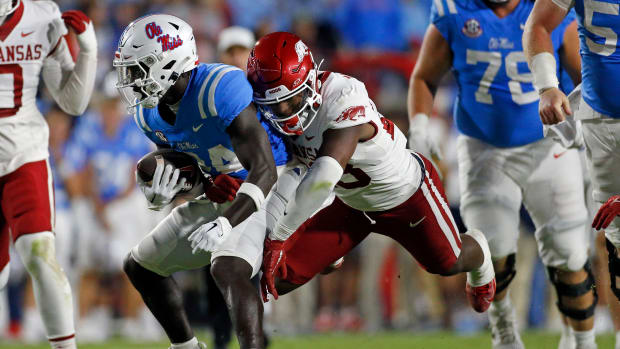 Oct 7, 2023; Oxford, Mississippi, USA; Mississippi Rebels running back Ulysses Bentley IV (24) runs the ball as Arkansas Razorbacks linebacker Jaheim Thomas (28) makes the tackle during the first half at Vaught-Hemingway Stadium. Mandatory Credit: Petre Thomas-USA TODAY Sports  